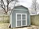 Gray storage shed with white trim in backyard at 2104 N Ball Ave, Muncie, IN 47304