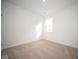 Well-lit bedroom with neutral carpet and walls, and a single window at 5559 Tart Blvd, Indianapolis, IN 46239