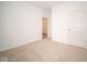 Simple bedroom with neutral walls, carpet, and a door leading to another room at 5559 Tart Blvd, Indianapolis, IN 46239