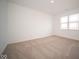 Spacious bedroom with neutral carpeting and large window at 5559 Tart Blvd, Indianapolis, IN 46239