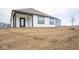 Rear view of a new construction home featuring a covered patio and modern siding at 5559 Tart Blvd, Indianapolis, IN 46239