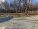 Spacious backyard with gravel area and mature trees at 5800 S State Rd 37, Tipton, IN 46072