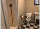 Small bathroom with shower, toilet and checkerboard floors at 5800 S State Rd 37, Tipton, IN 46072