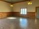 Large common area with wood wall accents and tile floors at 5800 S State Rd 37, Tipton, IN 46072