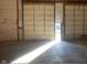 Bright garage interior with large doors at 5800 S State Rd 37, Tipton, IN 46072