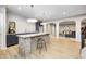 Open concept basement bar with island, dark cabinets and view to the living area at 16298 Grand Cypress Dr, Noblesville, IN 46060