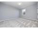 Spacious basement bedroom with light gray walls and patterned carpet at 16298 Grand Cypress Dr, Noblesville, IN 46060