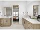 Elegant bathroom with dual vanities, a large mirror, and a view to the bedroom at 16298 Grand Cypress Dr, Noblesville, IN 46060