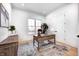 Bright home office with large window, wooden desk, and built-in shelving at 16298 Grand Cypress Dr, Noblesville, IN 46060