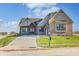 Brick house exterior with a large front yard and driveway at 16298 Grand Cypress Dr, Noblesville, IN 46060
