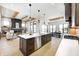 Open concept kitchen and living area with large island and stainless steel appliances at 16298 Grand Cypress Dr, Noblesville, IN 46060