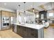 Open concept kitchen with island, stainless steel appliances, and living room view at 16298 Grand Cypress Dr, Noblesville, IN 46060