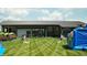 Large grassy area with cornhole and inflatable at 17366 Newton Main St, Westfield, IN 46074