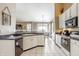 Well-designed kitchen with white cabinets, black appliances, and an island at 3726 W 46Th St, Indianapolis, IN 46228