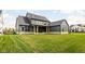 Spacious backyard offering a covered patio and expansive green space at 5187 Abington Way, Zionsville, IN 46077