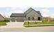 Two-car garage and welcoming front yard with landscaping at 5187 Abington Way, Zionsville, IN 46077