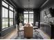 Dark-walled home office with built-in cabinetry and large windows at 5187 Abington Way, Zionsville, IN 46077