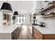 Modern kitchen with an eat-in island, white cabinets and a large window at 5187 Abington Way, Zionsville, IN 46077