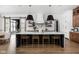 Modern kitchen with a large island, quartz countertops, and wooden cabinetry at 5187 Abington Way, Zionsville, IN 46077