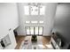 High-ceilinged living room with expansive windows and fireplace at 5187 Abington Way, Zionsville, IN 46077