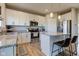 Spacious kitchen featuring white cabinets, granite countertops, and island seating at 8229 Lupine Dr, Plainfield, IN 46168