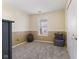 Simple bedroom with tan walls, carpet, and a window at 134 Thornburg Pkwy, Brownsburg, IN 46112