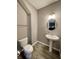 Modern bathroom with pedestal sink and a round mirror at 2834 Maricopa Blvd, Whitestown, IN 46075