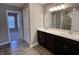 Double vanity bathroom with dark brown cabinets and a large mirror at 2834 Maricopa Blvd, Whitestown, IN 46075