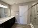 Modern bathroom with double vanity, shower, and wood-look flooring at 2834 Maricopa Blvd, Whitestown, IN 46075
