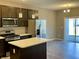 Modern kitchen with stainless steel appliances, island, and sliding door to patio at 2834 Maricopa Blvd, Whitestown, IN 46075