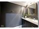 Modern bathroom with dark gray walls, gold fixtures, and marble vanity at 4127 N Sherman Dr, Indianapolis, IN 46226