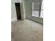 Empty carpeted bedroom with a closet and two windows at 5283 Tufton Dr, Indianapolis, IN 46254