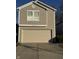 Tan two-story house with a beige garage door and a small front yard at 5283 Tufton Dr, Indianapolis, IN 46254