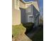 Side view of a tan house with green bushes and a walkway at 5283 Tufton Dr, Indianapolis, IN 46254