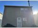 Rear view of a tan house with a door and two windows at 5283 Tufton Dr, Indianapolis, IN 46254