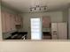 Kitchen with light-colored cabinets, black countertops, and appliances at 5283 Tufton Dr, Indianapolis, IN 46254