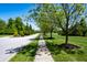 Residential street lined with mature trees and manicured lawns at 6055 Bluecrest Dr, Brownsburg, IN 46234
