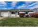 Ranch home with attached garage and well-manicured lawn at 8016 Minlo Dr, Indianapolis, IN 46227