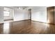 Open concept living room with hardwood floors and adjoining dining area at 8016 Minlo Dr, Indianapolis, IN 46227