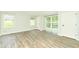 Light-filled bedroom featuring wood-look flooring and multiple windows at 103 Lake Vista Dr, Fishers, IN 46038