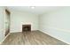 Dining room with fireplace, wood floors, and window blinds at 103 Lake Vista Dr, Fishers, IN 46038