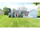 White house with red door, attached garage, and landscaped lawn at 103 Lake Vista Dr, Fishers, IN 46038