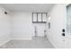 Bright laundry room with white wood-paneled walls and hexagon floor tile at 1110 N 15Th St, Noblesville, IN 46060