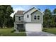 Two-story house with green siding, white garage door, and landscaping at 1126 Lona Dr, Martinsville, IN 46151