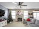 Cozy living room with fireplace, Christmas tree, and sectional sofa at 12438 Berry Patch Ln, Fishers, IN 46037