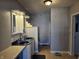 Bathroom with double vanity, shower, and updated fixtures at 1517 N E St, Elwood, IN 46036