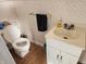 Small bathroom with toilet, sink, and gold-colored fixtures at 1517 N E St, Elwood, IN 46036