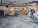 Spacious garage interior with tools, storage, and workbench area at 1517 N E St, Elwood, IN 46036