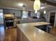 Kitchen featuring gray cabinets, stainless steel appliances, and an island with wood paneling at 1517 N E St, Elwood, IN 46036