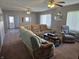 Living room featuring carpeted floors, a sectional sofa, recliner, and coffee table at 1517 N E St, Elwood, IN 46036